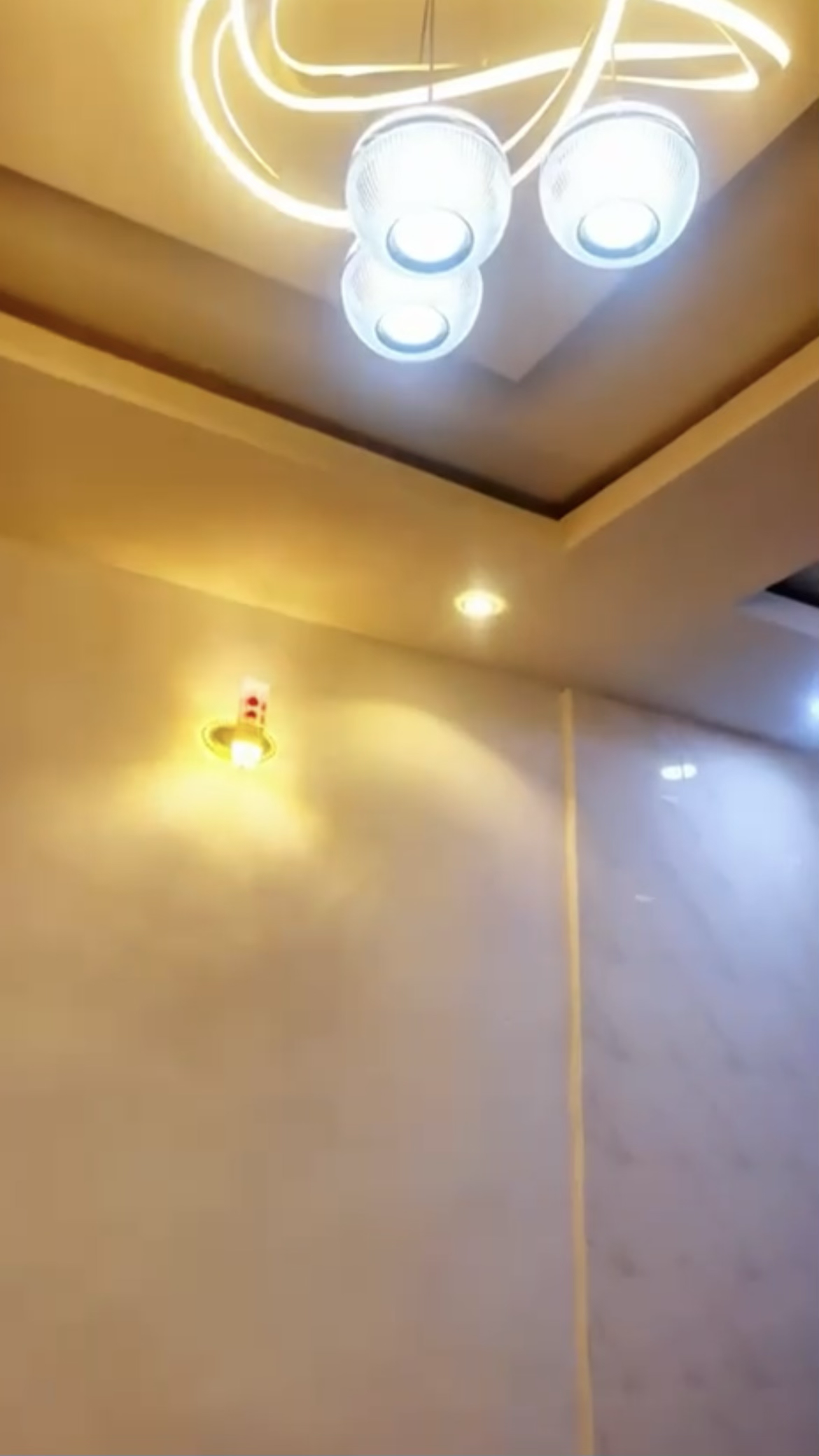 Decorative pendant lighting and wall light at Laimon Apartment